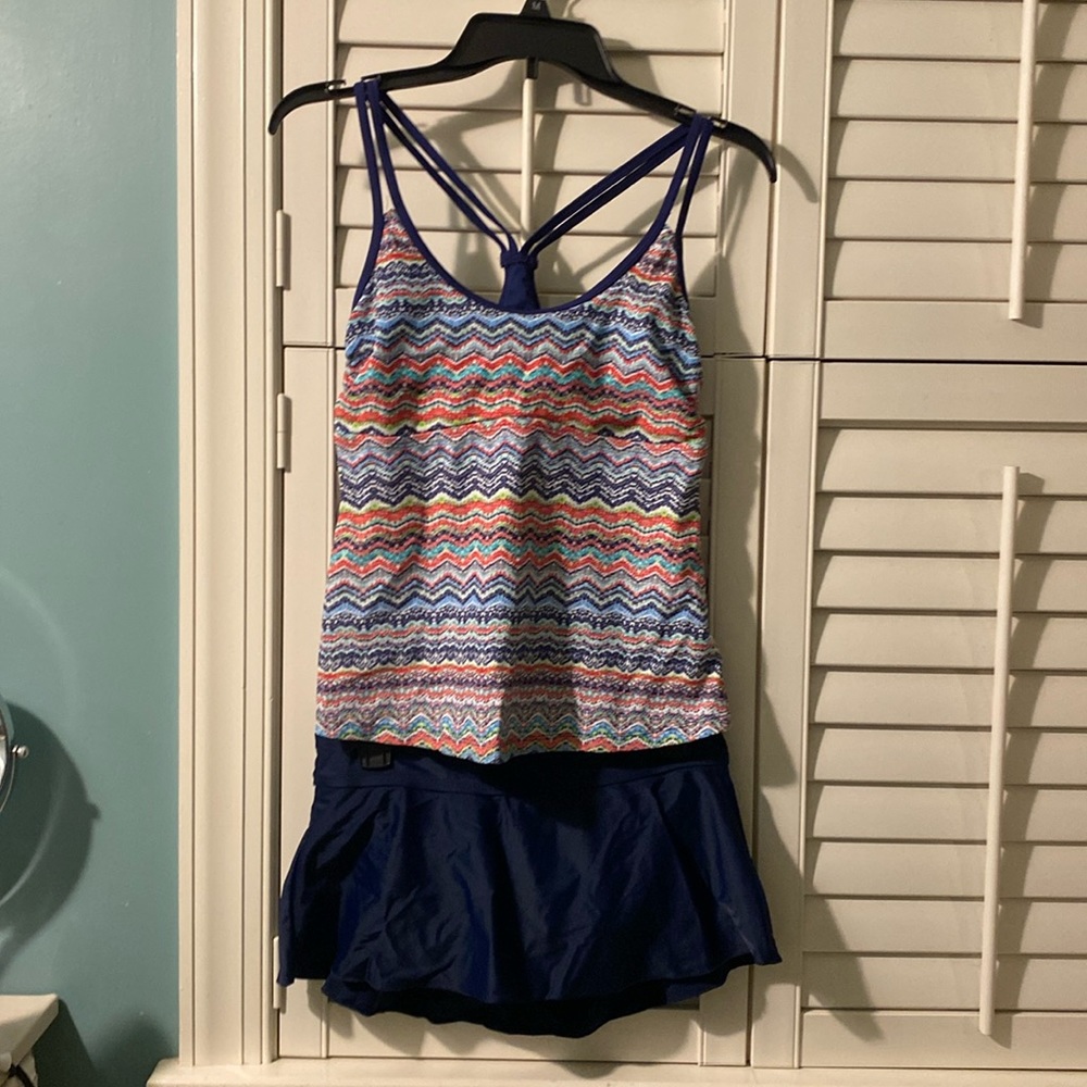 Two peice bathing suit. Navy bottom, multi colored top. Size M